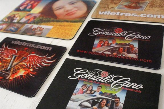 A collection of promotional coasters featuring various images and logos.